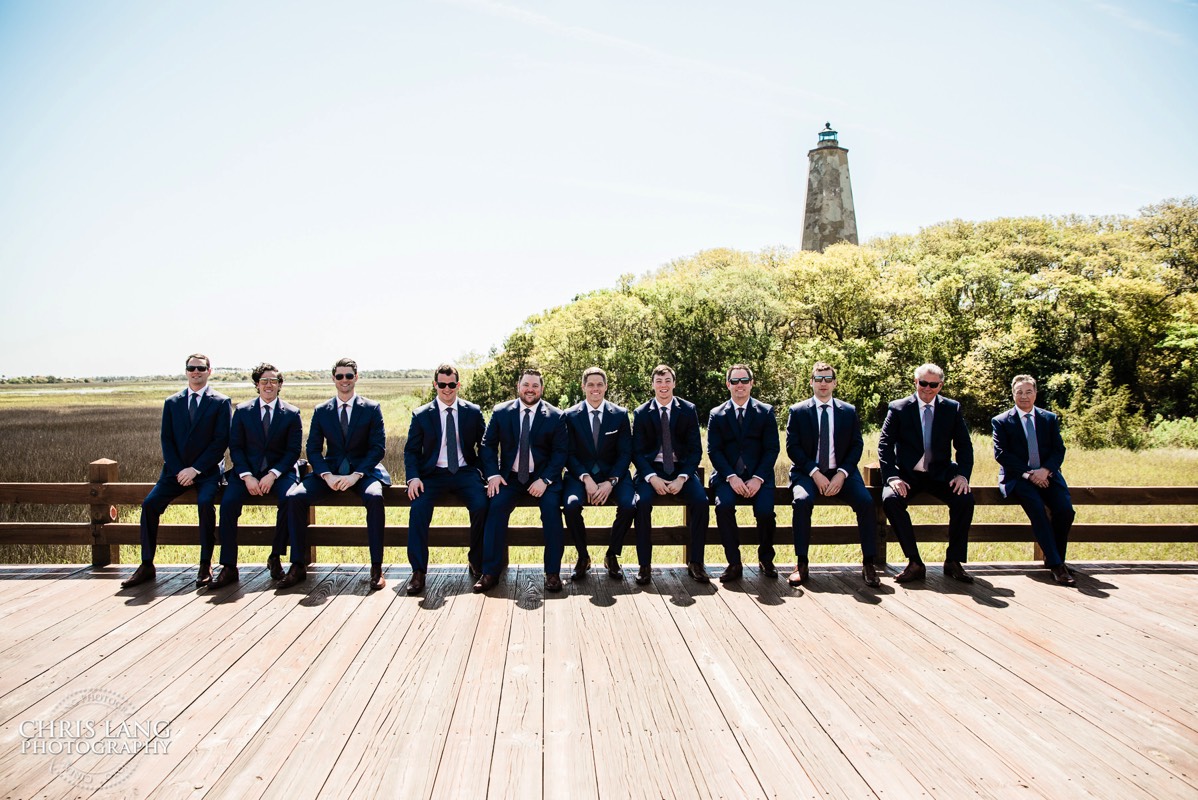 groomsmen picture in fron of Old Baldy Lighthouse -  - Bald Head Island NC Wedding Photography - BHI Wedding Photographers - Wedding Dress -  Chris Lang Photography - Destination Weddings -  Bald Head Island wedding picture - BHI Weddings