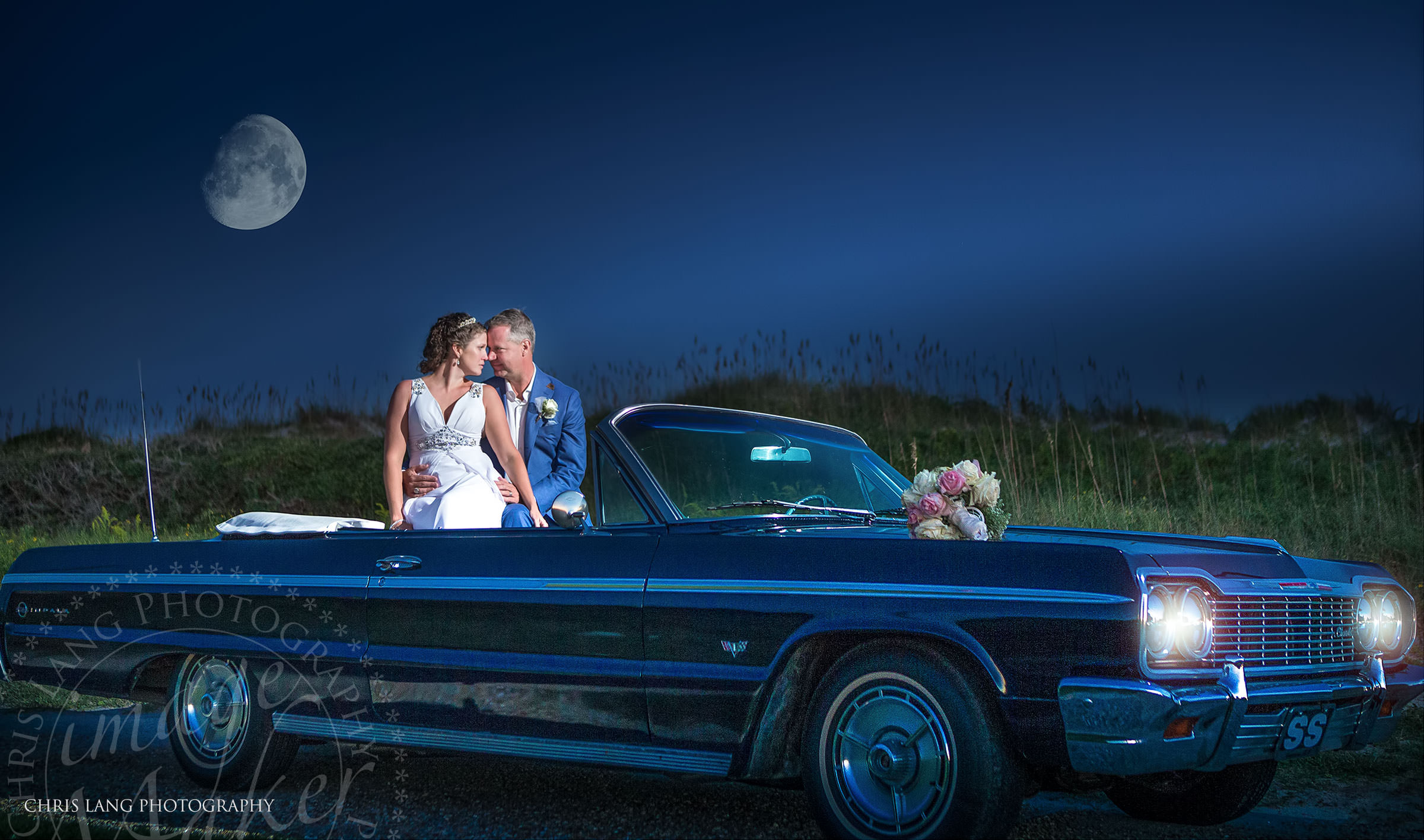 Wilmington NC Photographer - Chris Lang -  Image of bride & groom in convertable on the beach in the moon light