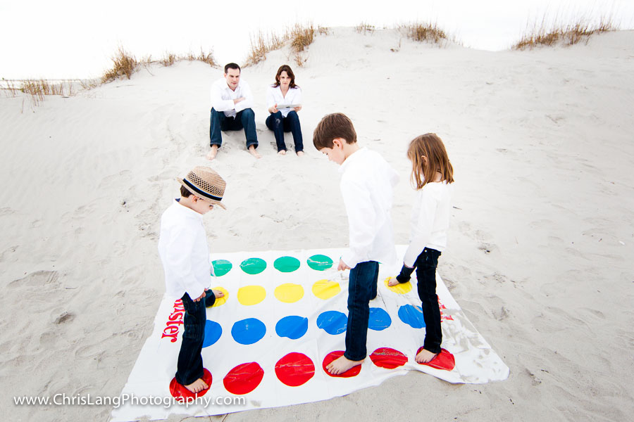 Picture of family playing twister on the beach