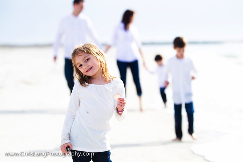 Young girl on beach with family at Wrightsville Beach