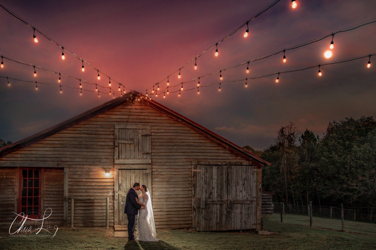 Bride & groom in fron of barn outside weddings   - farm weddings - vintage weding style -wilmington nc wedding photographers - creative wedding photo - signature portrats - wedding ideas - bride - groom - wedding dress - 